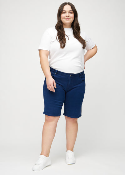 Fuldt billede af en plus-size model i mørkeblå regular middle shorts.